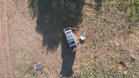 camper-van-camping-field-alone-isolated-social-distance-outdoors-recreation-grass-forest-summer-wisconsin-america-aerial-drone-ascending-rising