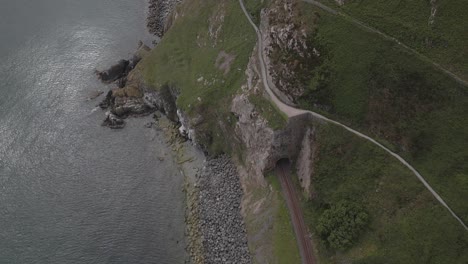 Train-Rail-In-Cliff-Walk-Trail-In-Bray,-Wicklow,-Ireland---aerial-shot