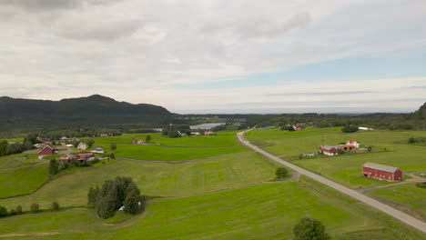 Aerial-shot-flying-over-a-farm-and-fields-in-the-rural-countryside-of-Norway