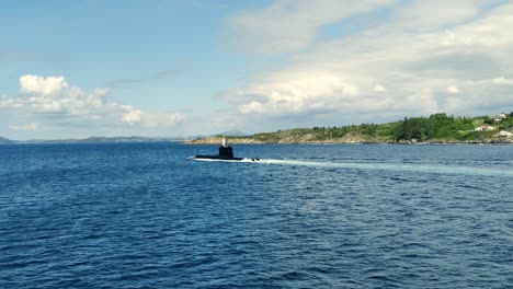 Viewing-a-black-NATO-submarine-from-the-side---Sailing-through-Norwegian-fjord-heading-for-Bergen