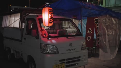 Traditional-ramen-food-truck-at-night,-wind-blowing-curtains-in-the-night