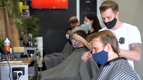Hairdressers-and-barbers-cut-hair-during-the-global-coronavirus-outbreak-that-has-impacted-many-businesses