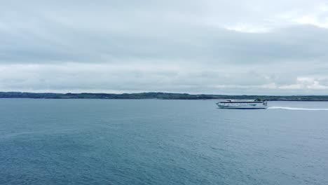 Irish-Ferries-passenger-transport-vessel-journey-across-Irish-sea-leaving-Holyhead-to-Dublin-aerial-view-panning-left