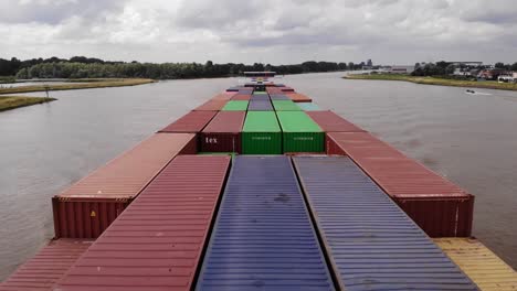 Aerial-View-Of-Ivernia-Cargo-Container-Ship-Pass-Underneath-On-River-Noord