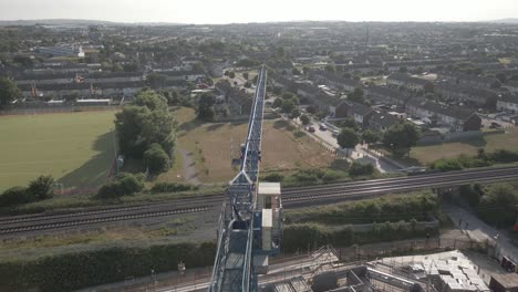 Aerial-View-Of-A-Construction-Crane-At-The-Housing-Development-Site-In-Balbriggan,-Ireland