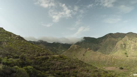 Beautiful-clouds-rolling-over-mountain-range-in-northern-Tenerife-island,-time-lapse-shot