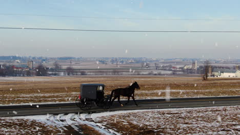 AERIAL-Horse-And-Buggy-Driving-Along-Snowy-Country-Road