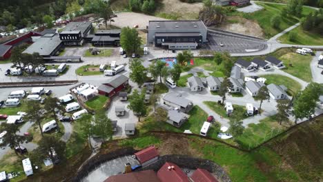 Kinsarvik-camping---Aerial-view-of-camping-spot-full-of-cabins-and-caravans-in-summer-vacation---Norway