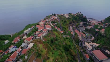 Hotel-Buildings-On-Top-Of-Lush-Green-Cliff-With-Overview-Of-Misty-Atlantic-Ocean-In-Ponta-Do-Sol,-Archipelago-Of-Madeira-In-Portugal