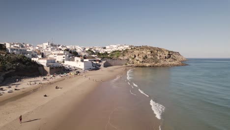 People-at-the-Burgau-sand-beach-enjoying-small-ocean-waves-and-sun
