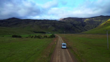 Van-Driving-On-Trail-Through-Green-Fields-To-Seljavallalaug-In-Iceland