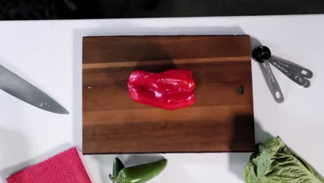 Slow-motion-overhead-of-pepper-being-chopped-in-half