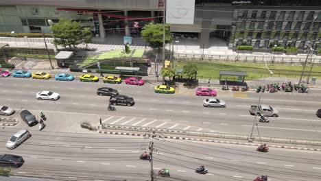 High-angle-view-of-Traffic-around-Ratchadaphisek-Road,-Rama-9-Intersection,-near-department-stores-during-the-Covid-19-situation-in-Bangkok,-Thailand