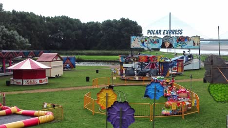 Empty-overcast-British-amusement-park-aerial-view-deserted-funfair-rides