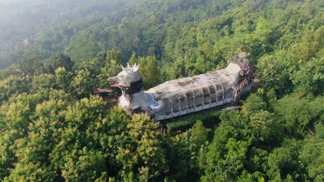 Famous-Chicken-Church-in-lush-green-tropical-forest-on-Java,-Indonesia,-aerial