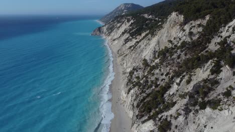 Fly-by-shot-of-the-coastline-and-beach-of-Egremni,-most-popular-tourist-location-in-Lefkada,-Greece