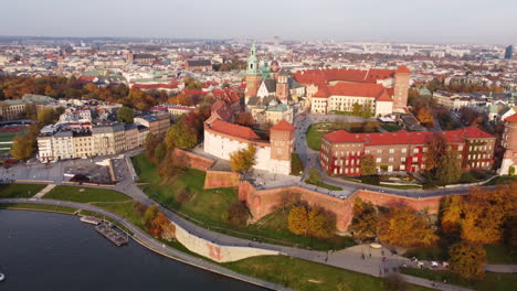 Wawel-Royal-Castle,-autumn-aerial-above-Vistula-Krakow-river,-day