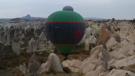 Beautiful-Hot-Air-Balloons-In-Rocky-Landscape-Of-Cappadocia,-Anatolia,-Turkey---aerial-drone-shot