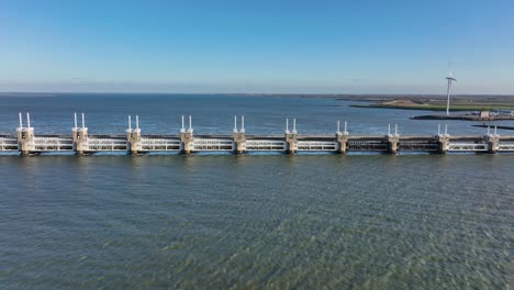 Aerial-shot-of-the-Eastern-Scheldt-storm-surge-barrier-in-Zeeland,-the-Netherlands,-on-a-beautiful-sunny-day