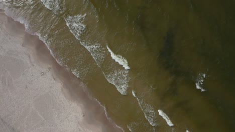 Malerischer-Blick-Auf-Den-Grünlichen-Strand-Mit-Einer-Einsamen-Person,-Die-Am-Ufer-Spazieren-Geht