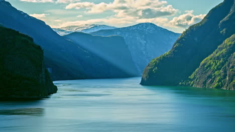 Cruise-ship-sailing-in-norwegian-fjords-between-mountain-hills,-destination-timelapse-in-Flam-Norway
