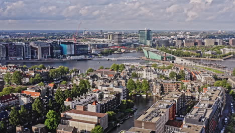 Amsterdam-Netherlands-Aerial-v37-pull-out-shot-away-from-nemo-science-museum-across-nieuwmarkt-en-lastage-neighborhood-capturing-beautiful-heritage-cityscape-at-downtown-metropolitan---August-2021