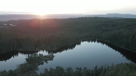 Tranquil-Waters-Of-Baklidammen-Lake-With-Abundant-Forest-During-Sunrise