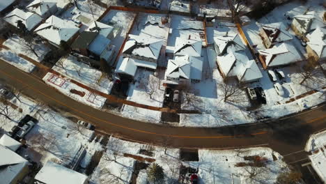 Aerial-flying-over-snow-covered-homes-in-a-residential-neighborhood