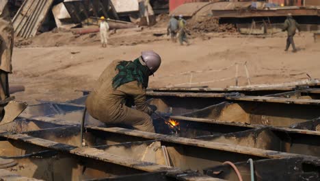 Male-Worker-Using-Acetylene-Torch-To-Cut-Metal-At-Gadani-Ship-Breaking-Yard