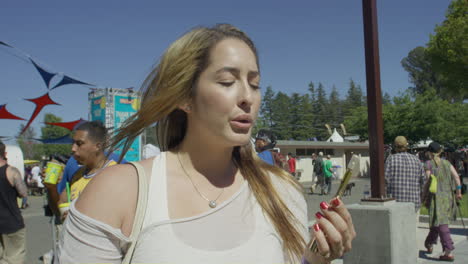 Cannabis-Festival-Event-Women-Smoking-Cannabis-Vape-Pen-Shot-on-RED-Camera-4K
