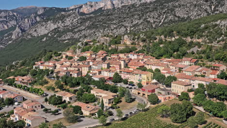 Aiguines-France-Aerial-v2-low-level-drone-flying-around-countryside-village-capturing-hillside-housing-townscape---July-2021