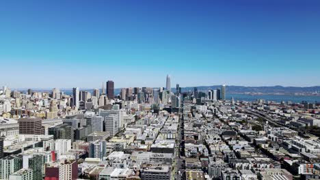 Aerial-Drone-view-of-San-Francisco-skyline-famous-downtown-buildings,-ocean-and-mountains-in-the-background