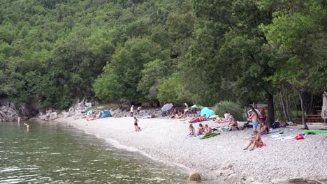 People-relax-and-sunbath-on-pebble-beach