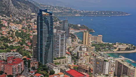 Monaco-Aerial-v21-birds-eye-view-overlooking-st-roman-neighborhood,-capturing-famous-odeon-tower-and-surrounding-residential-properties-and-resorts---July-2021