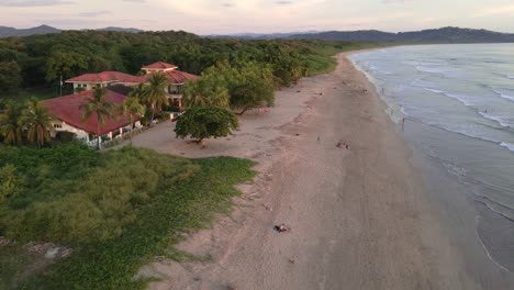 Fast-fly-over-at-Playa-Grande-near-Tamarindo,-Costa-Rica-during-warm-and-vibrant-sunset