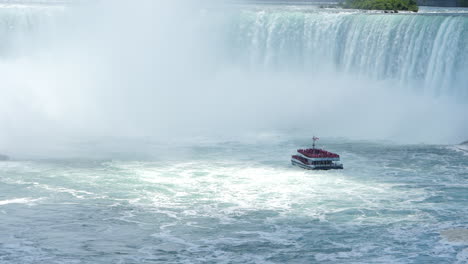Tourism-tour-ferry-approaching-the-waterfall-rapids-of-Niagara-Falls