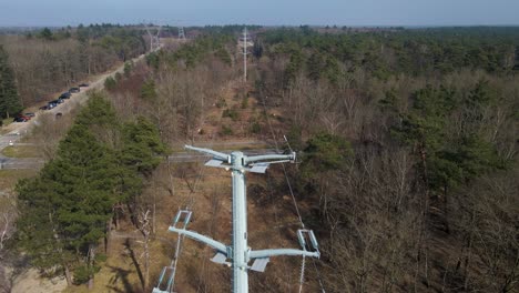Aerial-Upwards-view-of-high-voltage-lines-in-the-woods,-Electricity-distribution-station