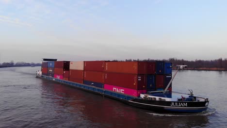 Aerial-View-Juliam-Cargo-Container-Freighter-Ship-Going-Past-On-Oude-Maas