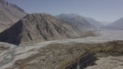 Aerial-View-Of-Skardu-Rugged-Valley-Landscape-With-River-Flowing-Through