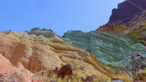 Bottom-view-of-colorful-rocky-wall-in-desertic-area
