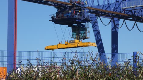 Shipping-container-crane-lift-loading-heavy-cargo-shipyard-containers-for-delivery-export