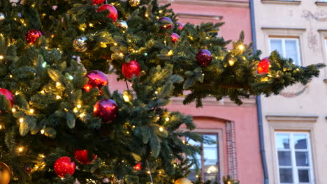 Christmas-tree-with-glass-balls-ornaments-glittering-at-dusk,-holiday-season
