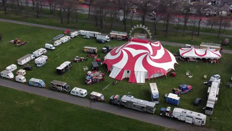 Planet-circus-daredevil-entertainment-colourful-swirl-tent-and-caravan-trailer-ring-aerial-view-slow-orbit-left