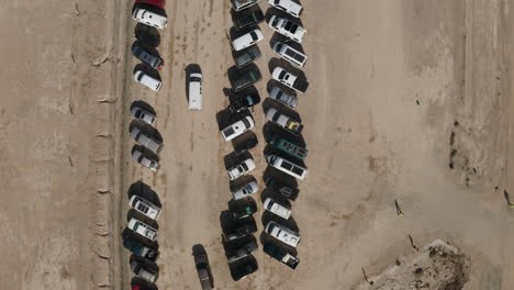 Top-down-aerial-view-of-a-van-looking-for-parking-in-the-desert