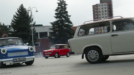 Convoy-of-Eastern-European-Trabant-retro-classic-cars-drive-through-city-streets,-Veliko-Tarnovo