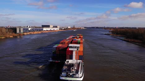 Aerial-View-As-Millennium-Ship-Carrying-Cargo-Containers-Travels-Past-Along-Oude-Maas