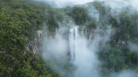 Unique-view-of-a-fog-covered-mountain-revealing-a-majestic-tropical-waterfall-lookout-platform