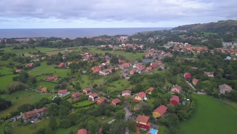 Panoramic-aerial-view-of-Santa-Marina-seaside-little-village-surrounded-by-green-nature