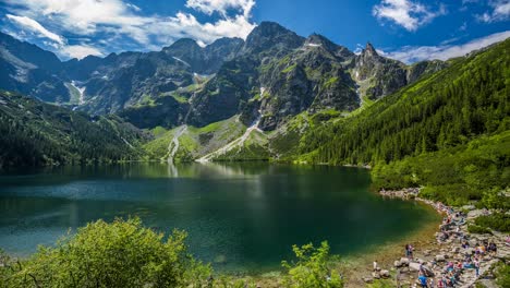 Poland-mountains-morskie-oko-Eye-of-the-Sea-a-lake-surrounded-by-mountains-top-peek-views-clear-clean-lake-timelapse-white-clouds-shadows-floating-by-near-town-of-zakopane-in-Tatra-Mountains