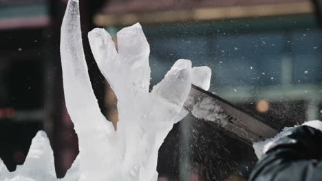 Close-up-view-of-chainsaw-blade-as-artist-shapes-deer-antlers-on-ice-sculpture